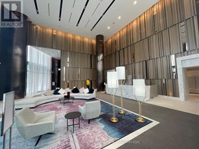 Toronto (North St. James Town) condo for rent - A modern living room with a large sofa, armchairs, and a coffee table.