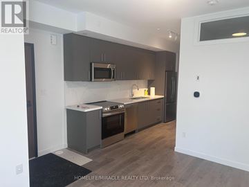 Markham (Middlefield) townhouse for rent - A modern kitchen with dark brown cabinets and stainless steel appliances.