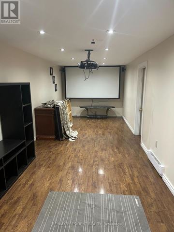 Toronto (Mount Olive-Silverstone-Jamestown) apartment for rent - A room with a wooden floor and a projector screen.