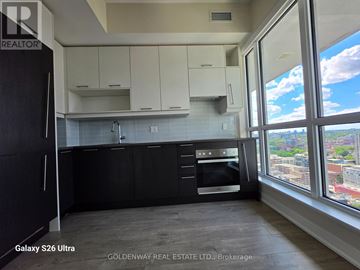 Toronto (Waterfront Communities) condo for rent - A kitchen with black cabinets and a Galaxy S26 Ultra fridge.