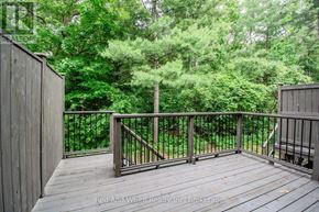 Cambridge townhouse for rent - A deck with a railing and trees in the background.