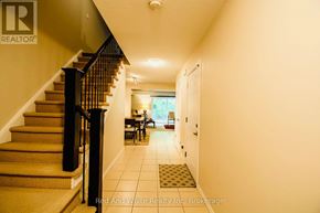 Cambridge townhouse for rent - A hallway with a staircase and a dining area in the background.