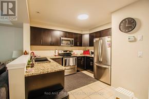 Cambridge townhouse for rent - A kitchen with a refrigerator, microwave, and oven.