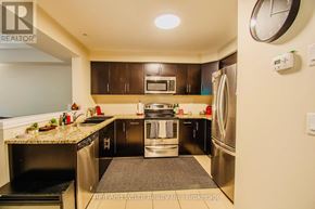 Cambridge townhouse for rent - A modern kitchen with stainless steel appliances and a granite countertop.