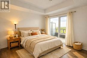 Newmarket (Huron Heights-Leslie Valley) condo for rent - A bedroom with a large bed, a nightstand with a lamp, and a view of the outdoors through a sliding glass door.