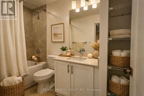 Newmarket (Huron Heights-Leslie Valley) condo for rent - A bathroom with a toilet, sink, and a mirror.