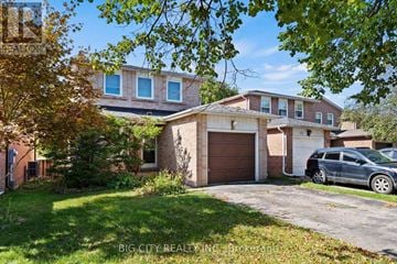 Markham (Old Markham Village) apartment for rent - A house with a garage and a car parked in front.