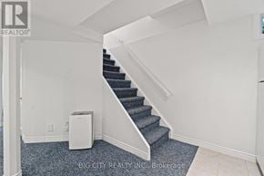 Markham (Old Markham Village) apartment for rent - A staircase with a carpeted floor and a wall-mounted air conditioner unit.