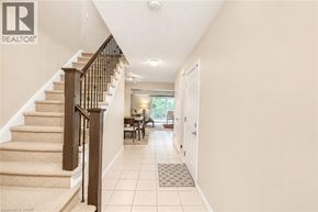 Cambridge townhouse for rent - A hallway with a staircase and a table with chairs.