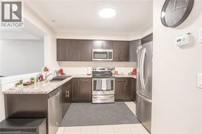 Cambridge townhouse for rent - A modern kitchen with stainless steel appliances and a granite countertop.