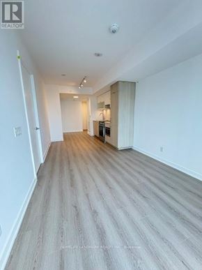 Toronto (Church-Yonge Corridor) condo for rent - A long, empty hallway with wood flooring and white walls.