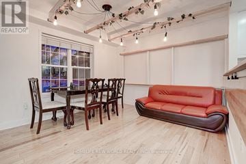 Mississauga (Cooksville) townhouse for rent - A living room with a red couch and a dining table with chairs.