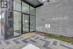 Brantford condo for rent - The entrance to a building with a glass door and a sign that reads "33 Erie Avenue".