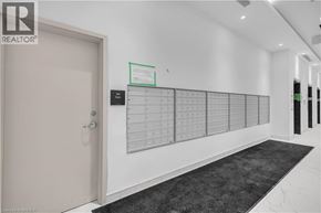 Brantford condo for rent - A white door with a calendar on the wall next to it.