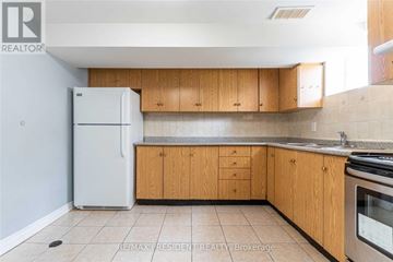 Brampton (Central Park) apartment for rent - A kitchen with wooden cabinets and a white refrigerator.