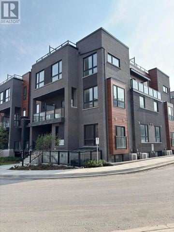 Newmarket (Glenway Estates) townhouse for rent - A modern apartment building with balconies and multiple windows.