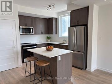 Newmarket (Glenway Estates) townhouse for rent - A kitchen with brown cabinets and a white island.