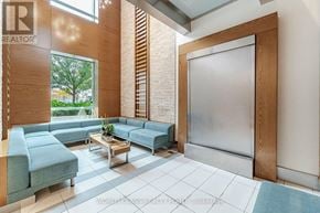 Toronto (Mimico) condo for rent - A living room with a sofa, a coffee table, and a glass door.