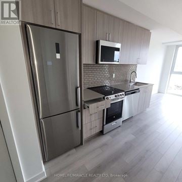 Oakville (Jm Joshua Meadows) condo for rent - A modern kitchen with a refrigerator, microwave, and stove top oven.