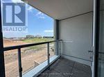 Oakville (Jm Joshua Meadows) condo for rent - A balcony with a glass door and a metal railing.