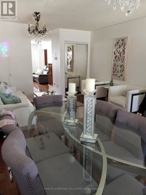 Mississauga (Churchill Meadows) apartment for rent - A glass table with a silver candle holder in the middle of it.
