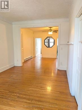Burlington (Brant) apartment for rent - A room with wooden floors and a mirror on the wall.