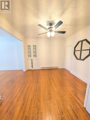Burlington (Brant) apartment for rent - A room with a ceiling fan and wooden flooring.