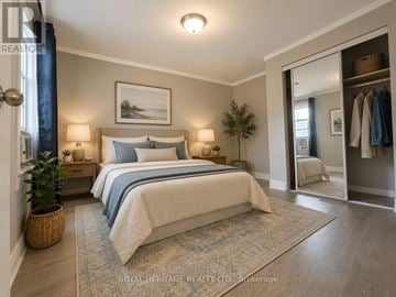 Oshawa (O'neill) duplex for rent - A bedroom with a large bed and a painting on the wall.