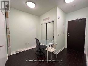 Toronto (Waterfront Communities) condo for rent - A small room with a desk and chairs.