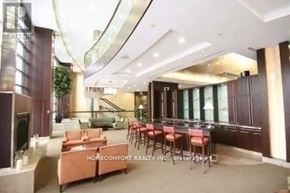 Toronto (Willowdale East) condo for rent - A spacious living room with a staircase and a dining area.