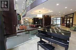 Toronto (Willowdale East) condo for rent - A piano in a showroom with a glass barrier.