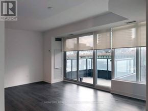 Toronto (Waterfront Communities) condo for rent - A spacious room with a view of the city through large windows.
