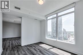 Toronto (Waterfront Communities) condo for rent - A room with a large window overlooking a cityscape.