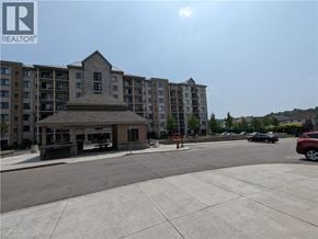 Waterloo condo for rent - A large building with a small structure in front of it.