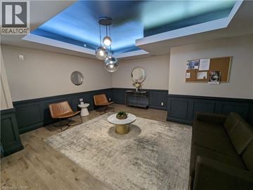 Waterloo condo for rent - A living room with a grey rug and brown chairs.