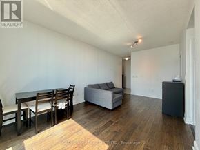 Toronto (Bendale) condo for rent - A living room with a dining table and chairs.