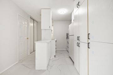 Gatineau (Hull) condo for rent - A kitchen with white cabinets and a marble floor.