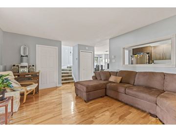 Gatineau (Hull) condo for rent - A living room with a brown couch and a wooden floor.