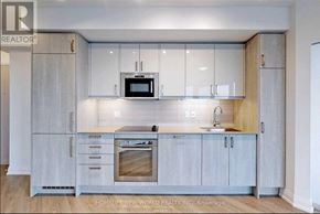 Toronto (Church-Yonge Corridor) condo for rent - A modern kitchen with a sink, stove, and microwave.