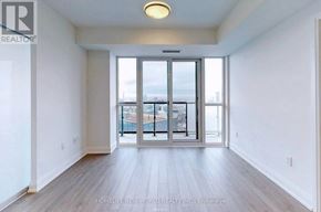 Toronto (Church-Yonge Corridor) condo for rent - A spacious room with a view of the city through a large window.