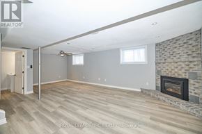 Welland (N. Welland) apartment for rent - A spacious room with a fireplace and wooden flooring.