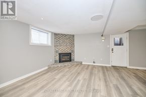 Welland (N. Welland) apartment for rent - A spacious room with a fireplace and wooden flooring.