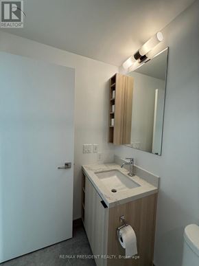 Toronto (Church-Yonge Corridor) condo for rent - A bathroom with a sink, mirror, and toilet paper holder.