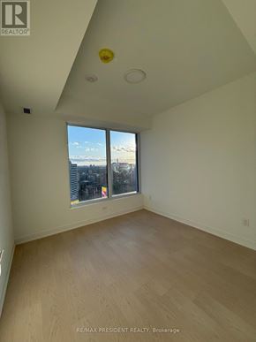 Toronto (Church-Yonge Corridor) condo for rent - A room with a large window and wooden flooring.