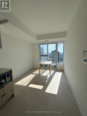 Toronto (Church-Yonge Corridor) condo for rent - A sunny day in a spacious, empty apartment with a view of the city.