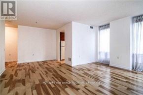 Toronto (Church-Yonge Corridor) condo for rent - A spacious room with wooden flooring and white walls.