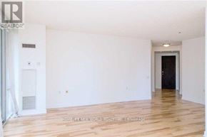Toronto (Church-Yonge Corridor) condo for rent - A room with wooden flooring and white walls, with a door on the right side.