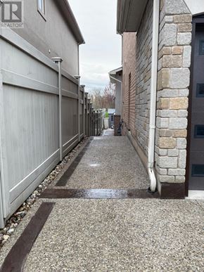 Oakville (Br Bronte) apartment for rent - A long concrete walkway between two houses.