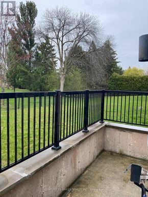 Oakville (Br Bronte) apartment for rent - A black metal fence surrounds a concrete patio.