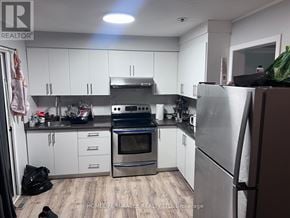 Brampton (Northgate) apartment for rent - A kitchen with white cabinets and a stainless steel refrigerator.